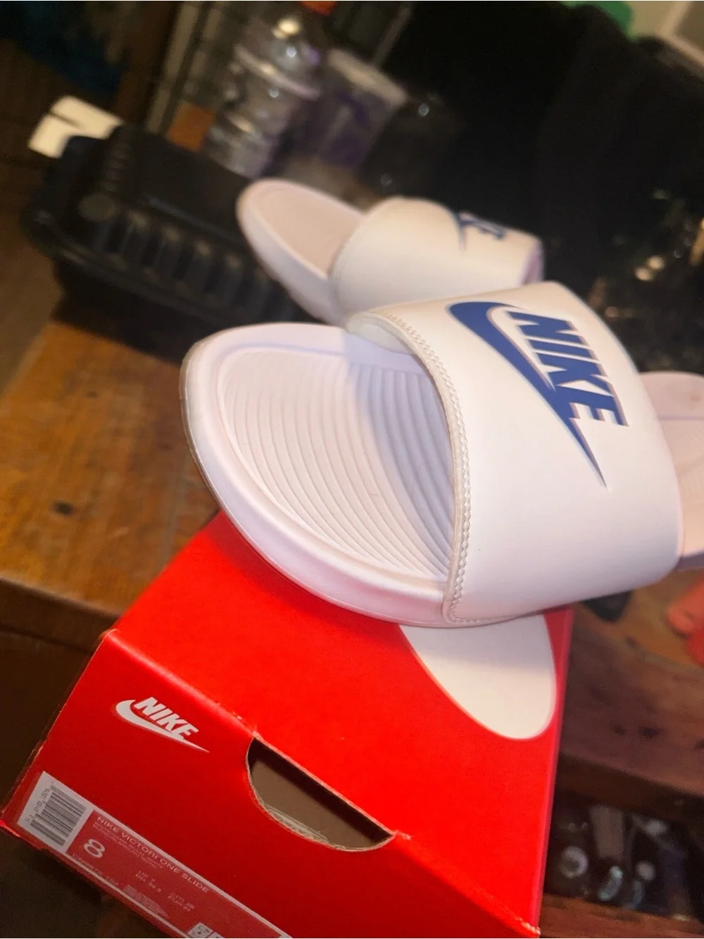 Nike White Slide Sandals with Blue Swoosh